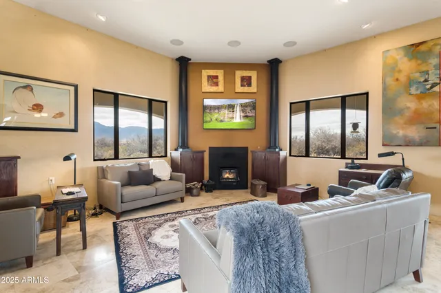 a kitchen with stainless steel appliances granite countertop a table chairs and a refrigerator