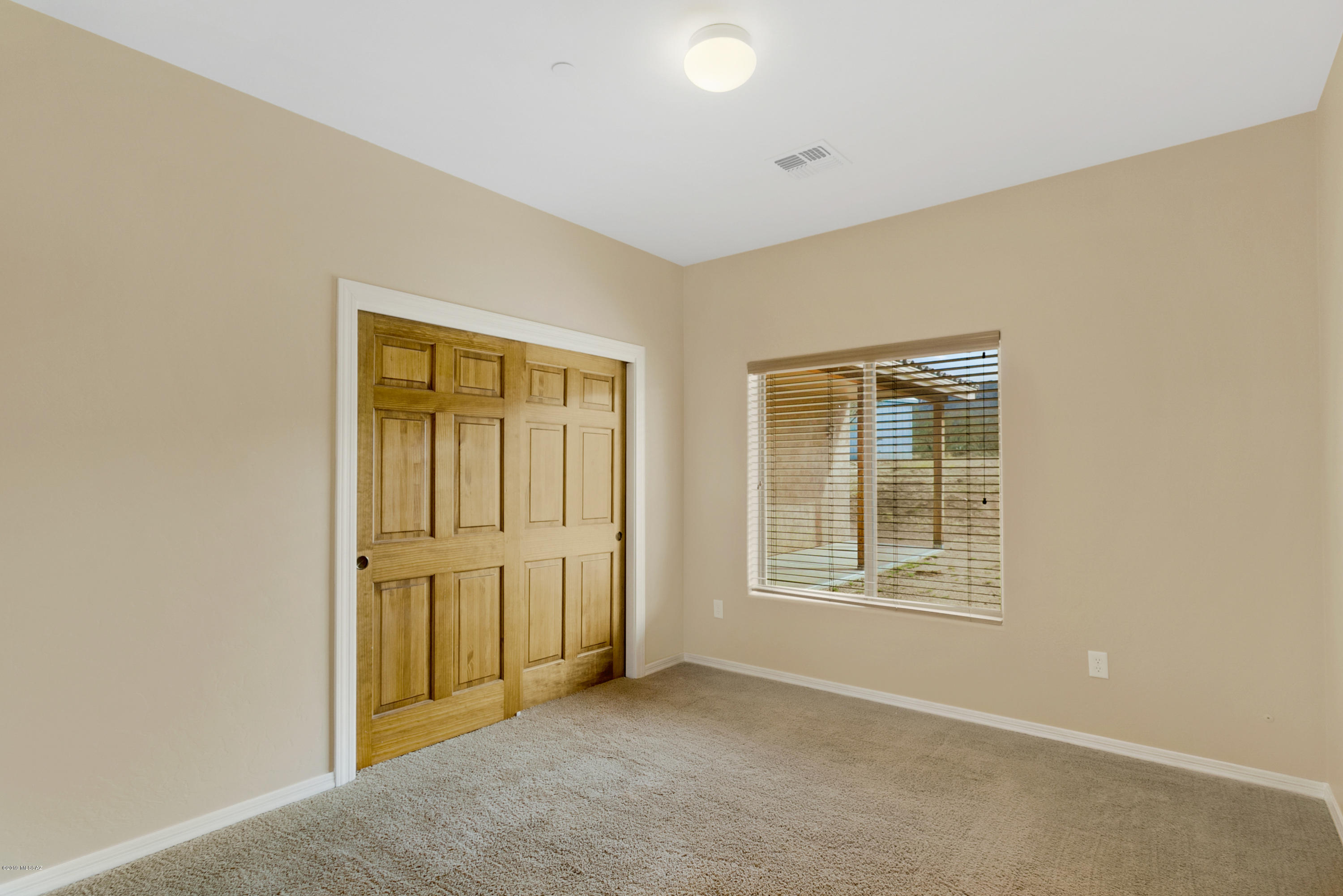 21960 South Helvetia Road Sahuarita, AZ 85629 - Photo 14 of 29 an empty room with windows