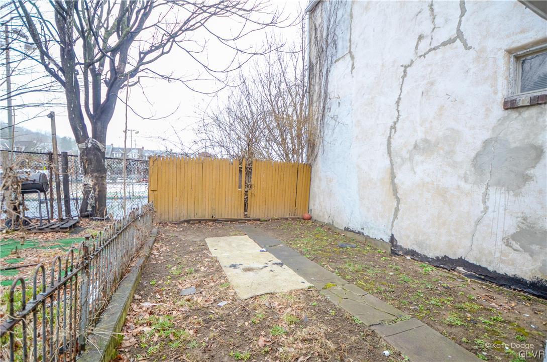 606 Hayes Street Bethlehem, PA 18015 - Photo 12 of 12 a view of a backyard with brick wall and a large tree