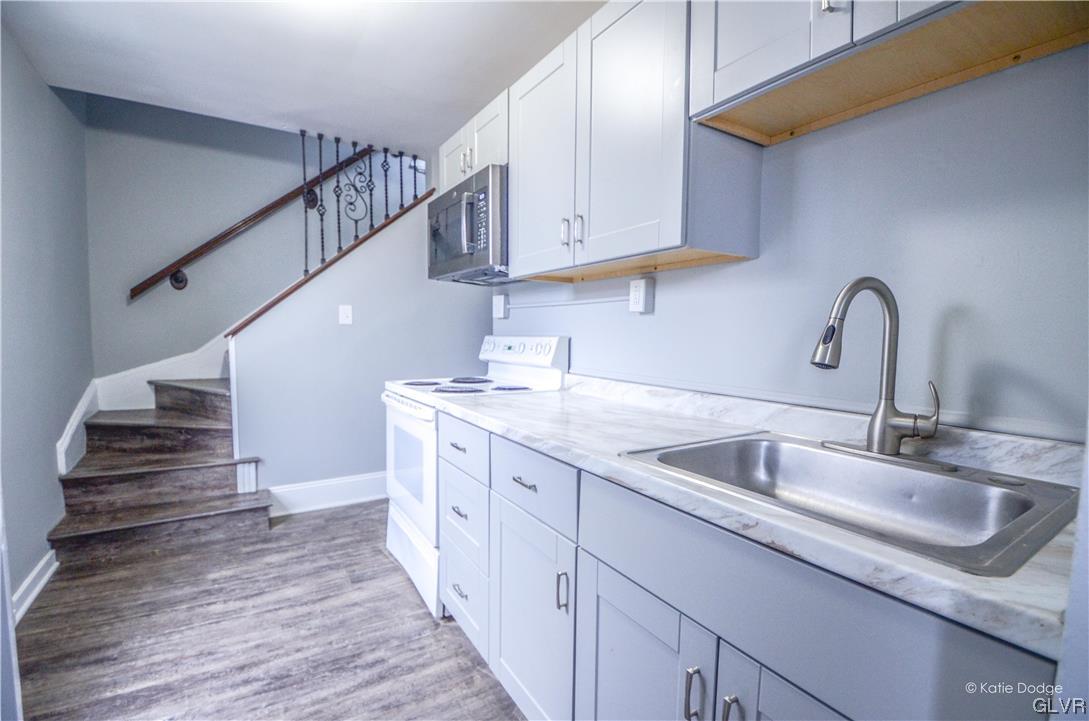 606 Hayes Street Bethlehem, PA 18015 - Photo 4 of 12 a kitchen with stainless steel appliances granite countertop a sink and cabinets
