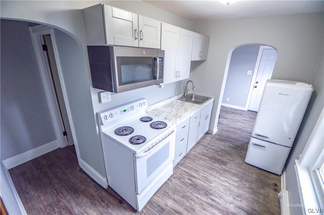 606 Hayes Street Bethlehem, PA 18015 - Photo 5 of 12 a white stove top oven sitting inside of a kitchen