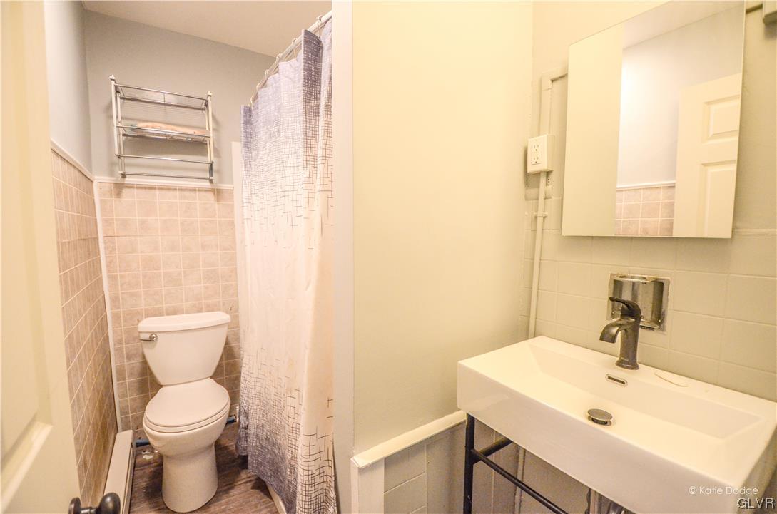 606 Hayes Street Bethlehem, PA 18015 - Photo 6 of 12 a bathroom with a toilet sink and mirror