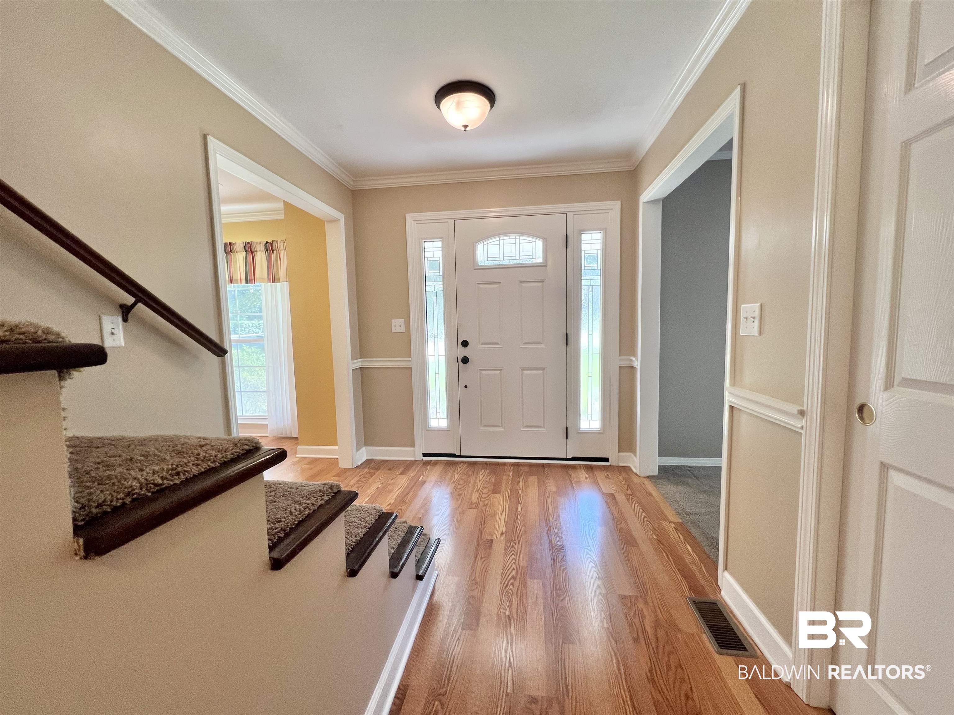 2691 Appleton Road Brewton, AL 36426 - Photo 21 of 60 Entrance foyer with ornamental molding, light wood-style flooring, and stairway