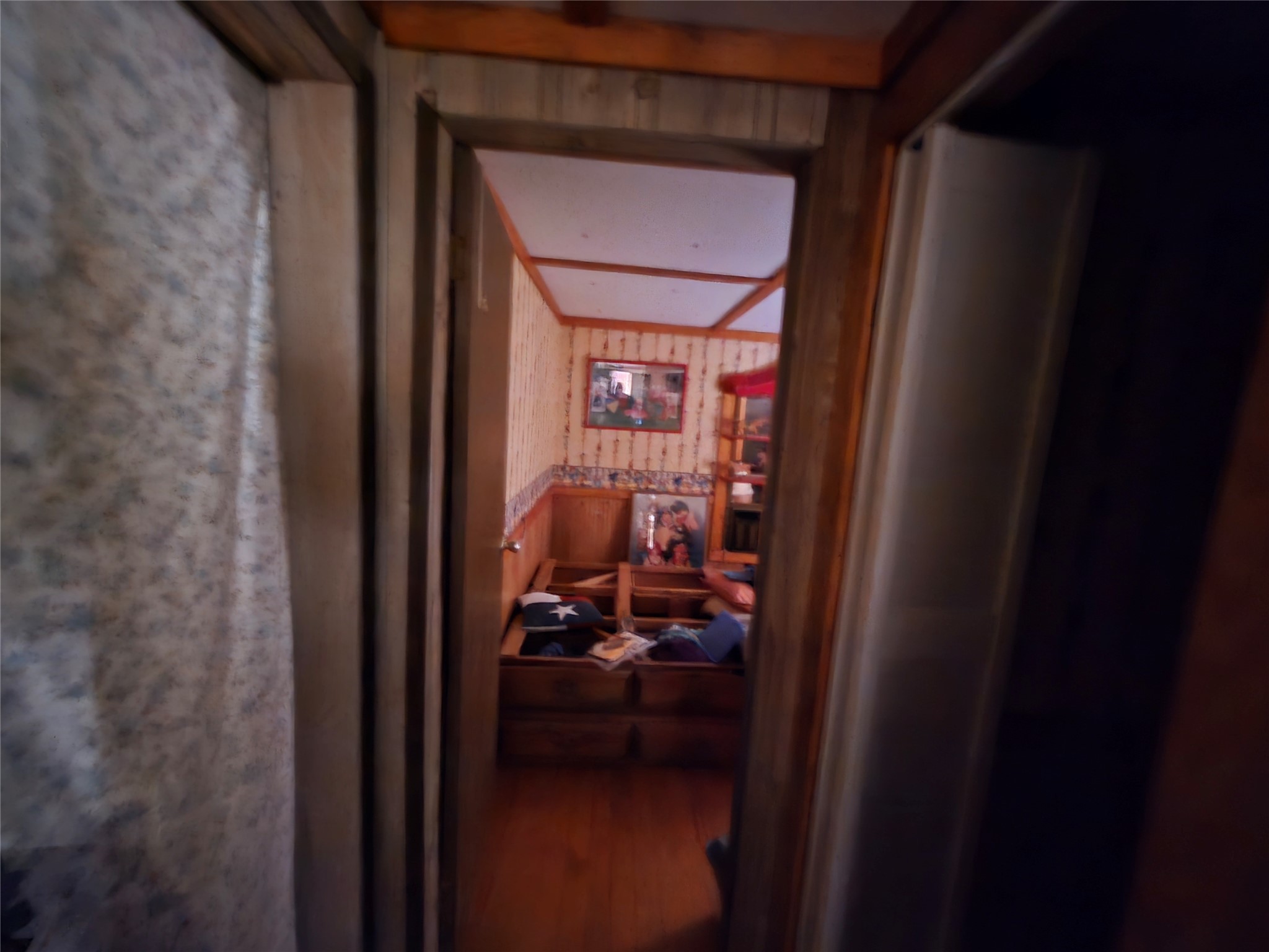 1188 Sportsman Drive Trinity, TX 75862 - Photo 20 of 26 a view of a hallway with wooden floor and a livingroom with furniture