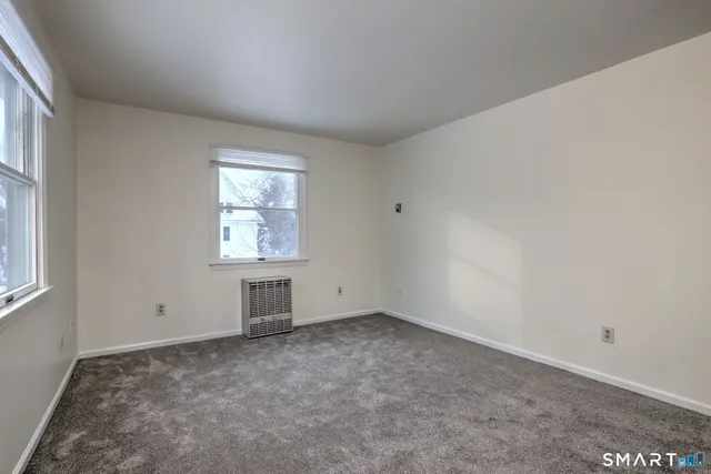 an empty room with chandelier fan