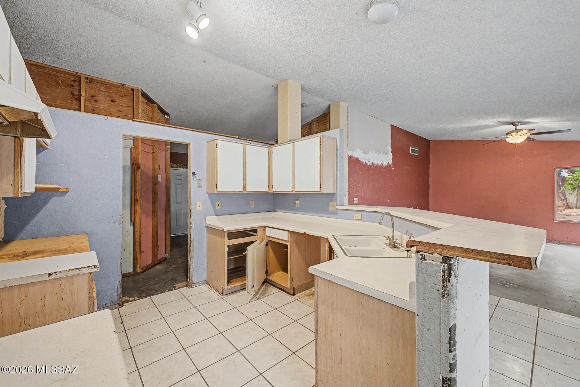 9810 East Stonehaven Way Tucson, AZ 85747 - Photo 15 of 27 a room with a sink a washer and dryer