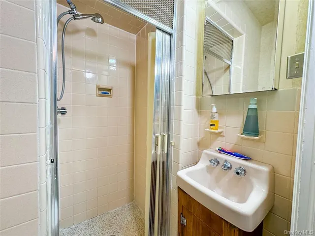 a white toilet sitting next to a bathroom shower and a sink