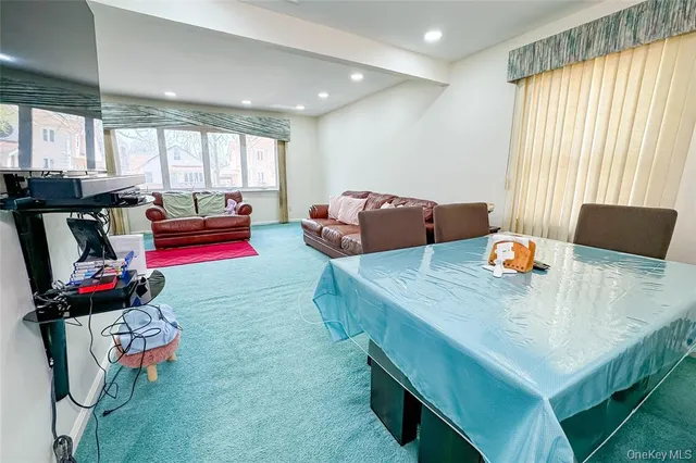 a living room with furniture and a gym machine