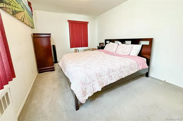 a large bed sitting in a bedroom next to a window