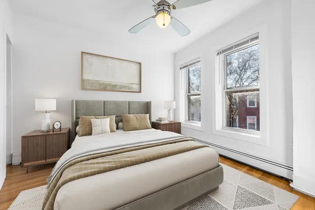 a bedroom with a bed and a potted plant