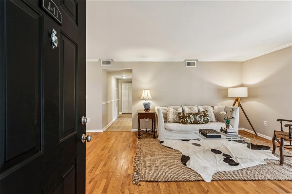 1150 Collier Road Northwest, Unit J11 Atlanta, GA 30318 - Photo 17 of 25 a bed room with a bed and a night stand