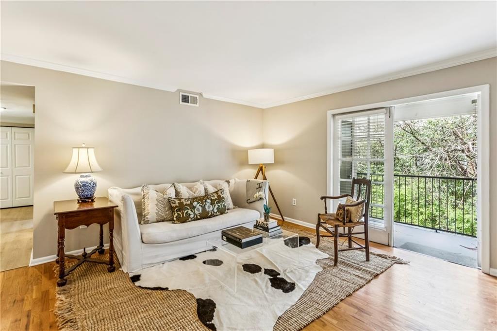 1150 Collier Road Northwest, Unit J11 Atlanta, GA 30318 - Photo 18 of 25 a living room with furniture and a large window