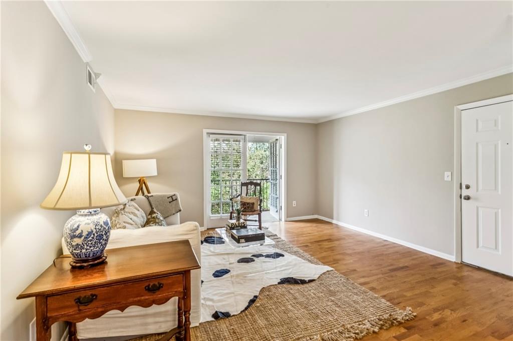 1150 Collier Road Northwest, Unit J11 Atlanta, GA 30318 - Photo 19 of 25 a bedroom with a bed and a window