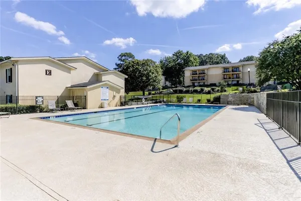 a swimming pool with outdoor seating and yard