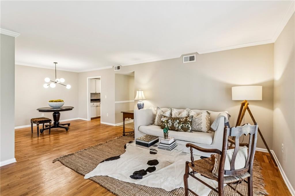 1150 Collier Road Northwest, Unit J11 Atlanta, GA 30318 - Photo 2 of 25 a living room with furniture and a table