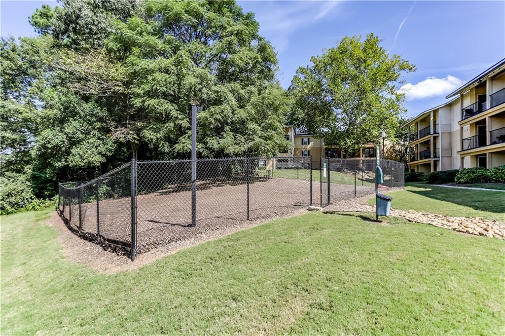 1150 Collier Road Northwest, Unit J11 Atlanta, GA 30318 - Photo 22 of 25 a garden with trees in the background