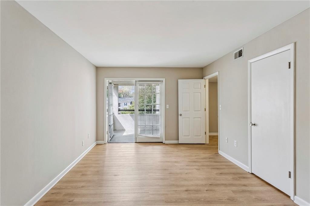 1150 Collier Road Northwest, Unit J11 Atlanta, GA 30318 - Photo 7 of 25 a view of empty room with wooden floor and fan