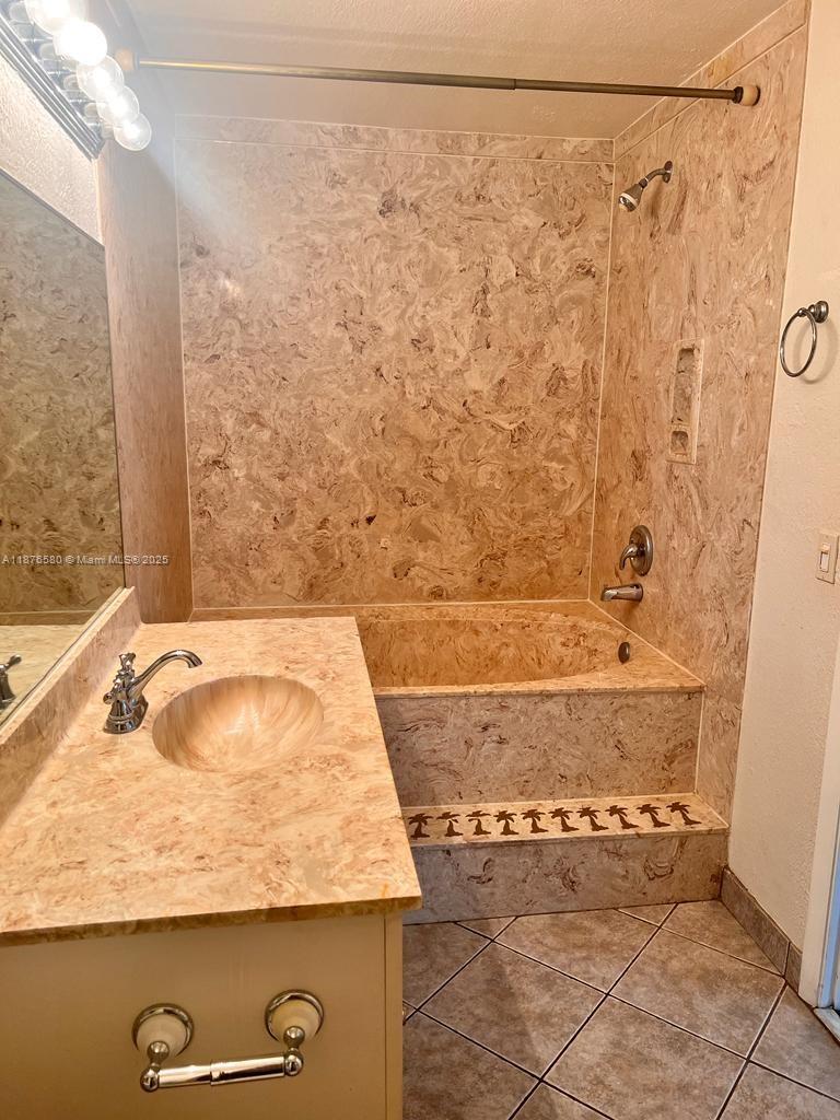 17 Crossings Circle, Unit E Boynton Beach, FL 33435 - Photo 13 of 20 a bathroom with a granite countertop sink and a mirror
