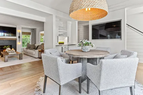 a kitchen with stainless steel appliances granite countertop a stove a sink and a granite counter tops with white cabinets