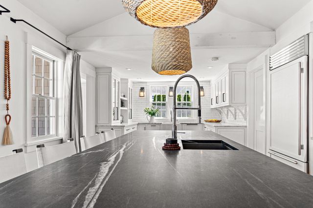 a spacious bedroom with a bed couch and a window