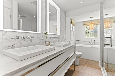 a bathroom with a granite countertop sink a toilet and bathtub