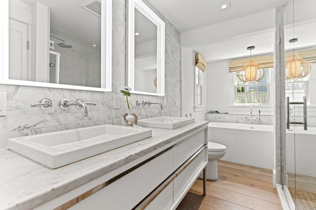 a bathroom with a granite countertop sink a toilet and bathtub