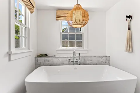 a living room with a bed furniture and a window