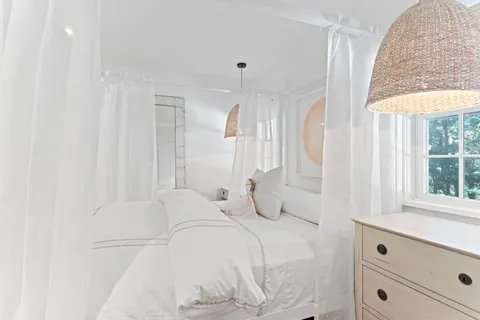 a bathroom with a granite countertop sink mirror and a toilet
