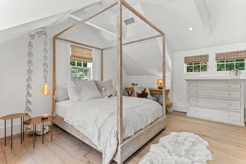 a view of a hallway with wooden floor and entryway