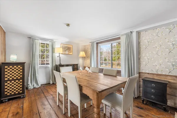 a view of a dining room with furniture window and wooden floor