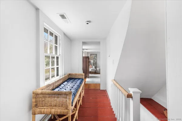 a spacious bedroom with a bed a couch and a window