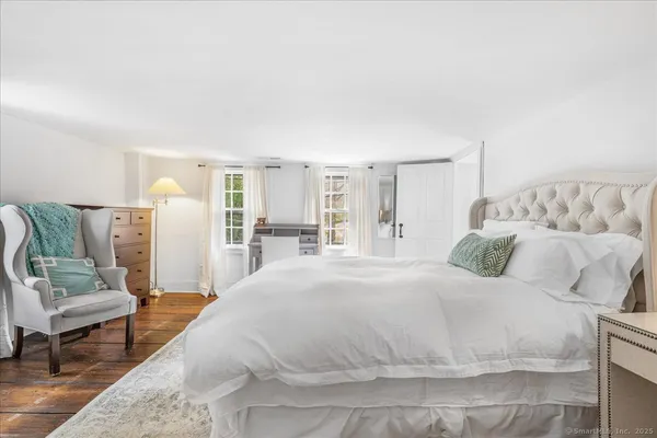 a bed room with furniture and a flat screen tv
