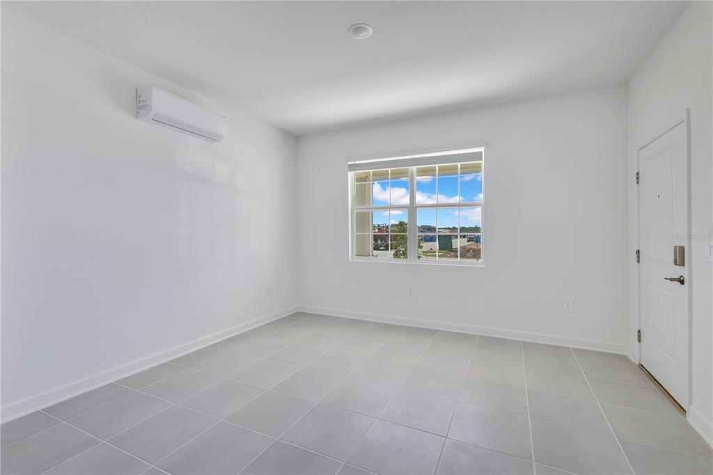 3257 Addison Boulevard, Unit B St. Cloud, FL 34771 - Photo 3 of 9 an empty room with windows