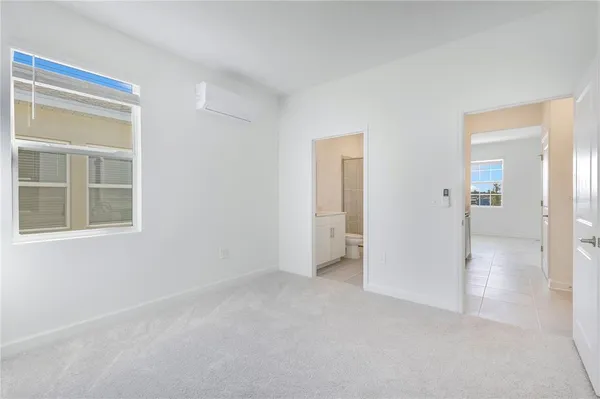 an empty room with windows and closet