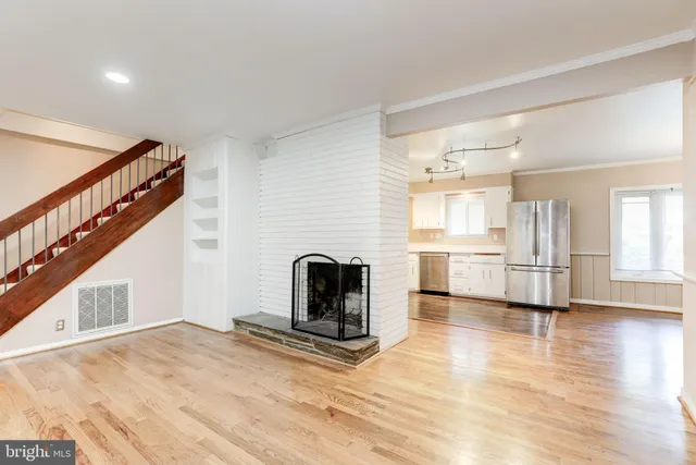a view of a livingroom with wooden floor and furniture