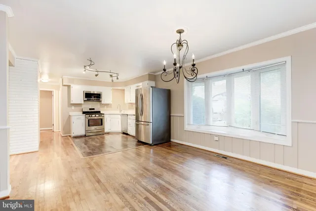 a view of a kitchen with wooden floor