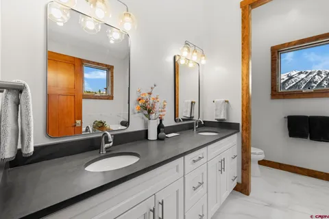 a bathroom with a double vanity sink and a mirror