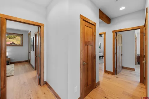 a view of hallway with wooden floor