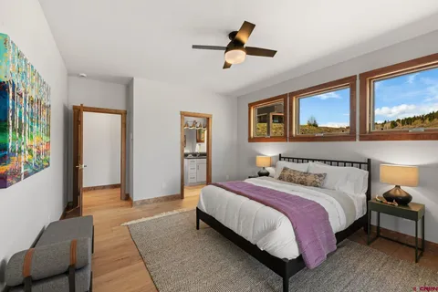 a bedroom with a bed a couch and a painting on the wall