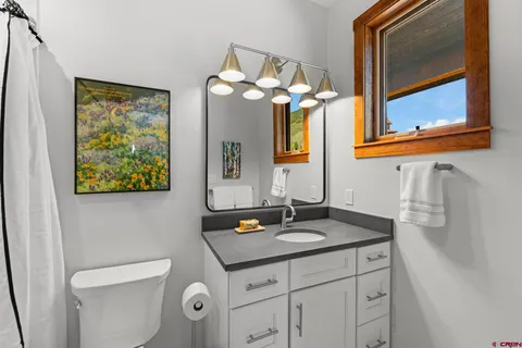a bathroom with a sink vanity and a mirror