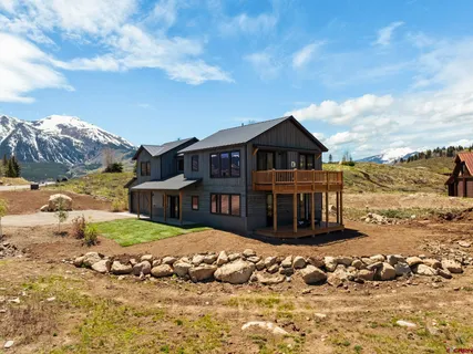 a view of a house with swimming pool and mountains in the background