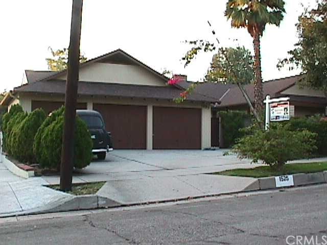 1525 Cleveland Road Glendale, CA 91202 - Photo 1 of 1 a front view of a house with a yard and garage