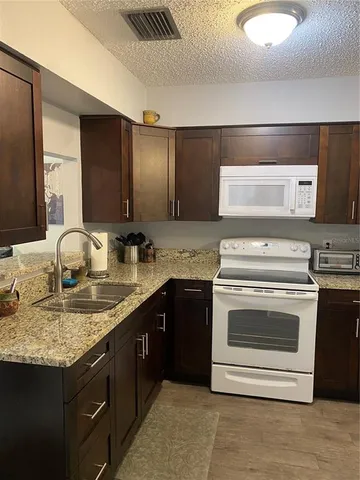 a kitchen with a stove and a sink