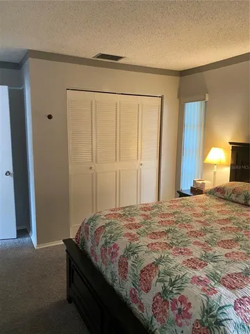a bedroom with a bed and a mirror