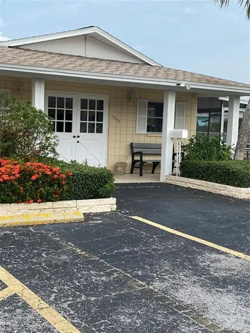 a front view of a house with a yard and a garage