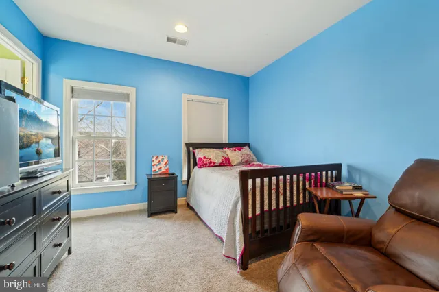 a bedroom with furniture and a flat screen tv