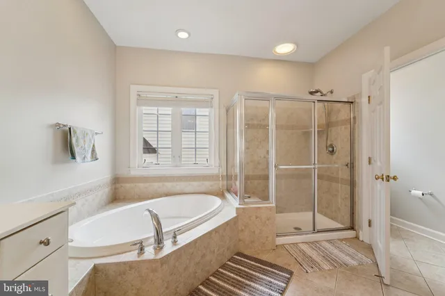 a bathroom with a tub shower and sink