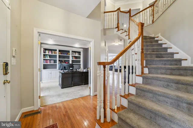 a view of staircase with white walls and railing