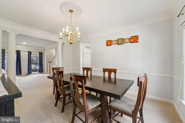 a view of a dining room with furniture and chandelier