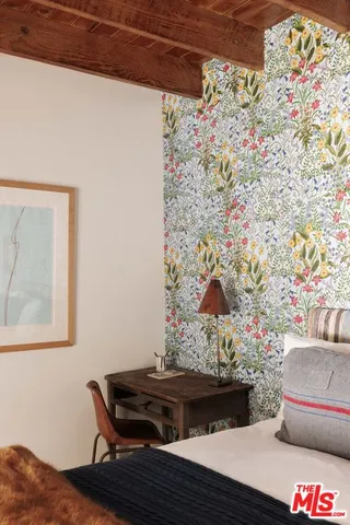 a living room with a couch and a potted plant